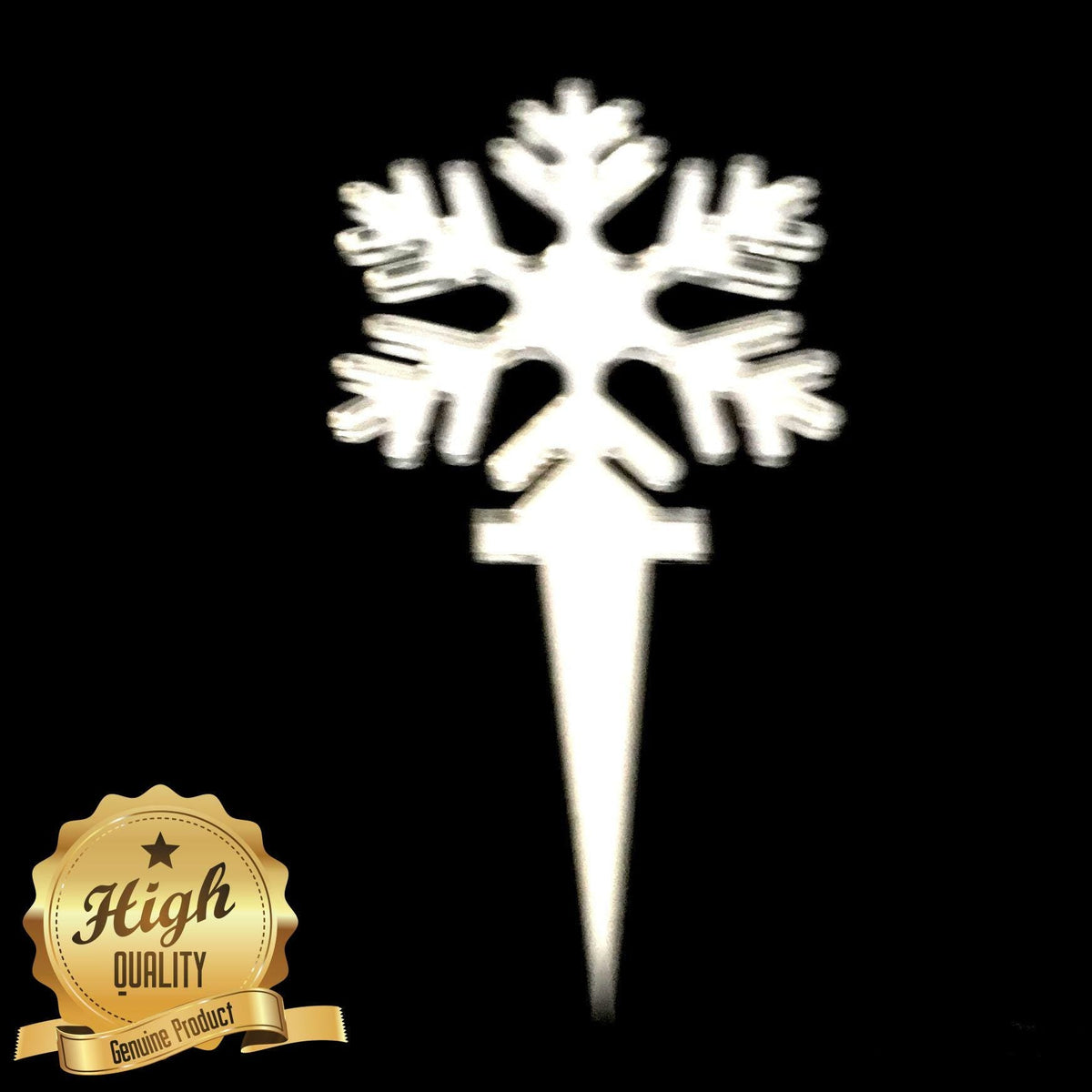 A white, six-pointed snowflake cake topper on a stake against a black background with a gold High Quality seal.