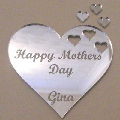 Silver acrylic heart mirror engraved with "Happy Mothers Day Gina" and three small heart cutouts.