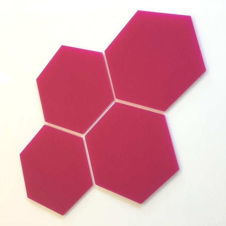 Four pink hexagon tiles arranged together on a white background.