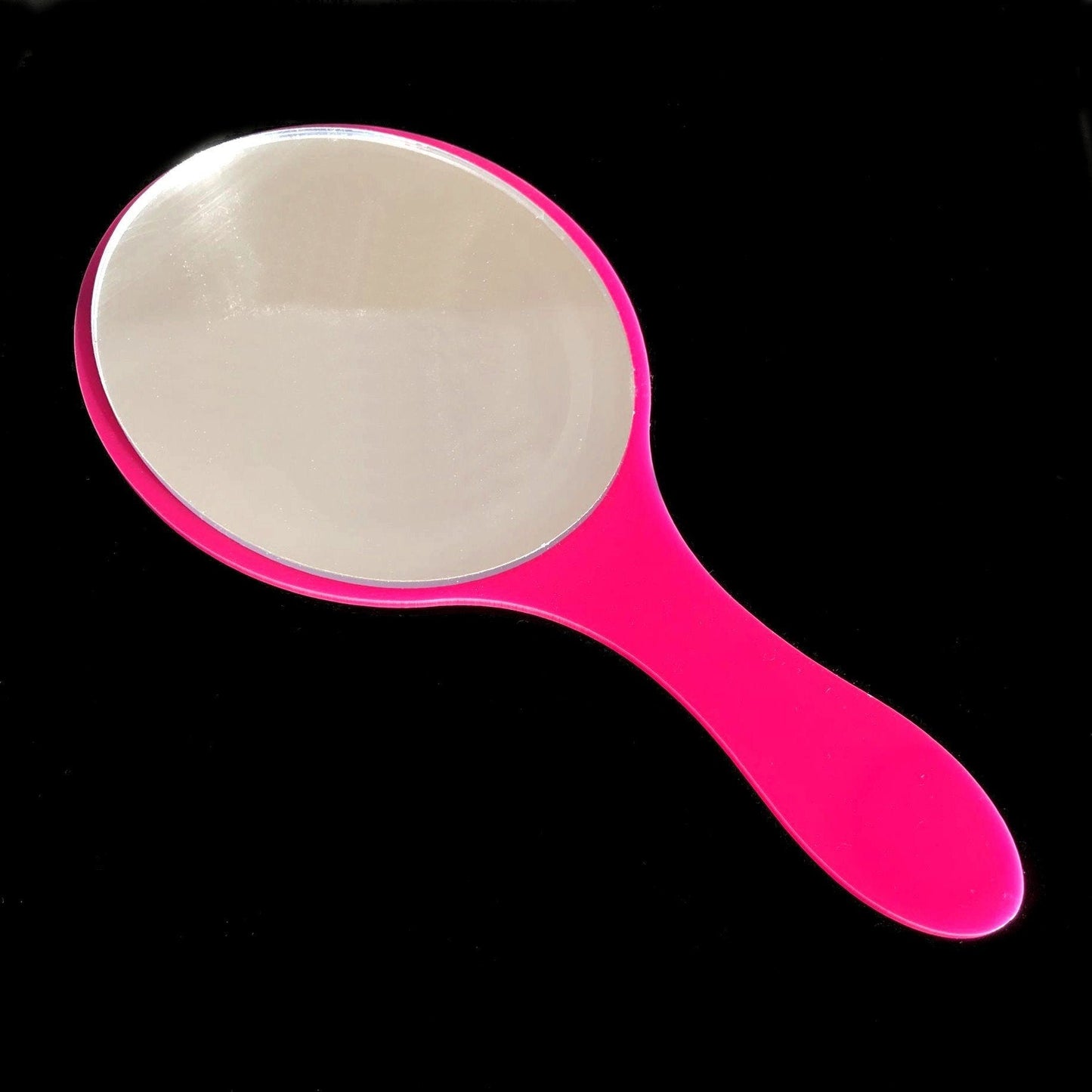 Oval hand-held mirror with a glossy hot pink handle.