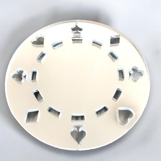 Round silver poker chip mirror with card suit cutouts arranged in a circle.