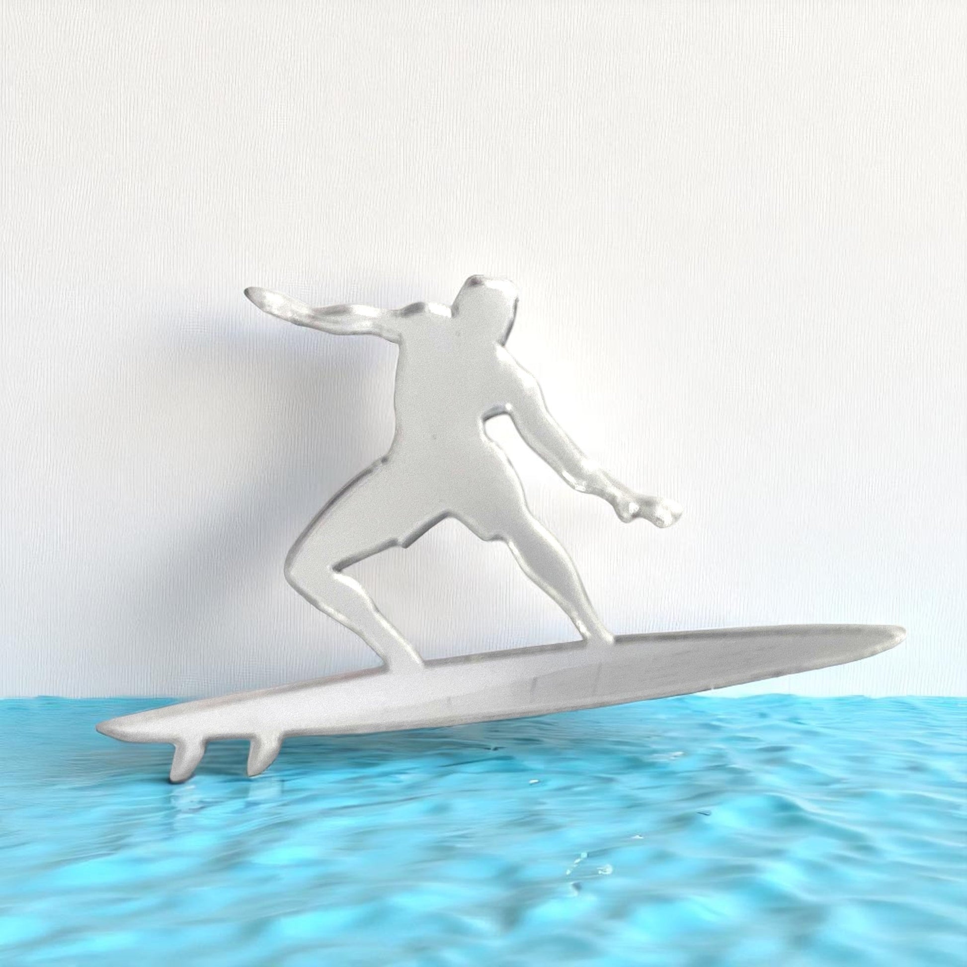 Surfer Mirror in the shape of a surfer riding a surfboard above blue water.