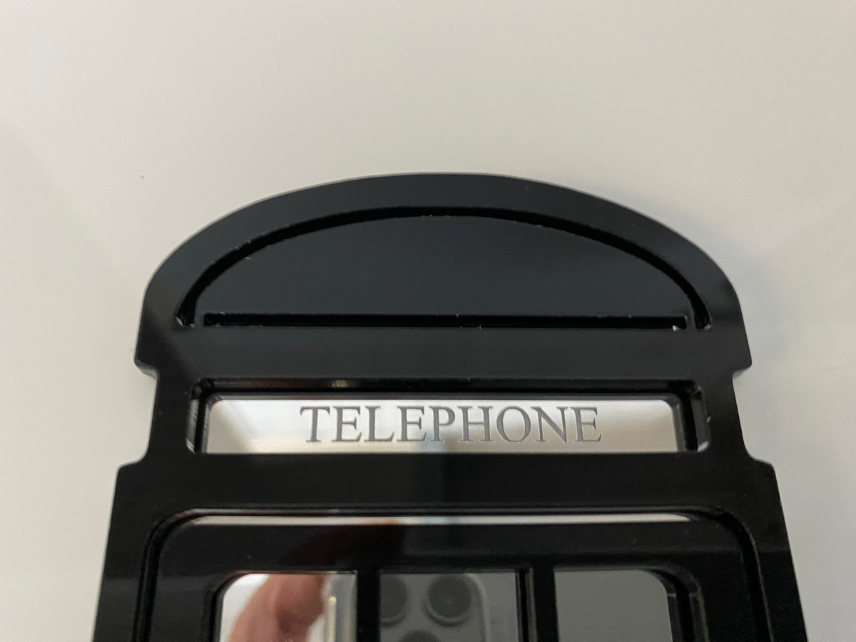 Black telephone box garden mirror top section with the word TELEPHONE printed.