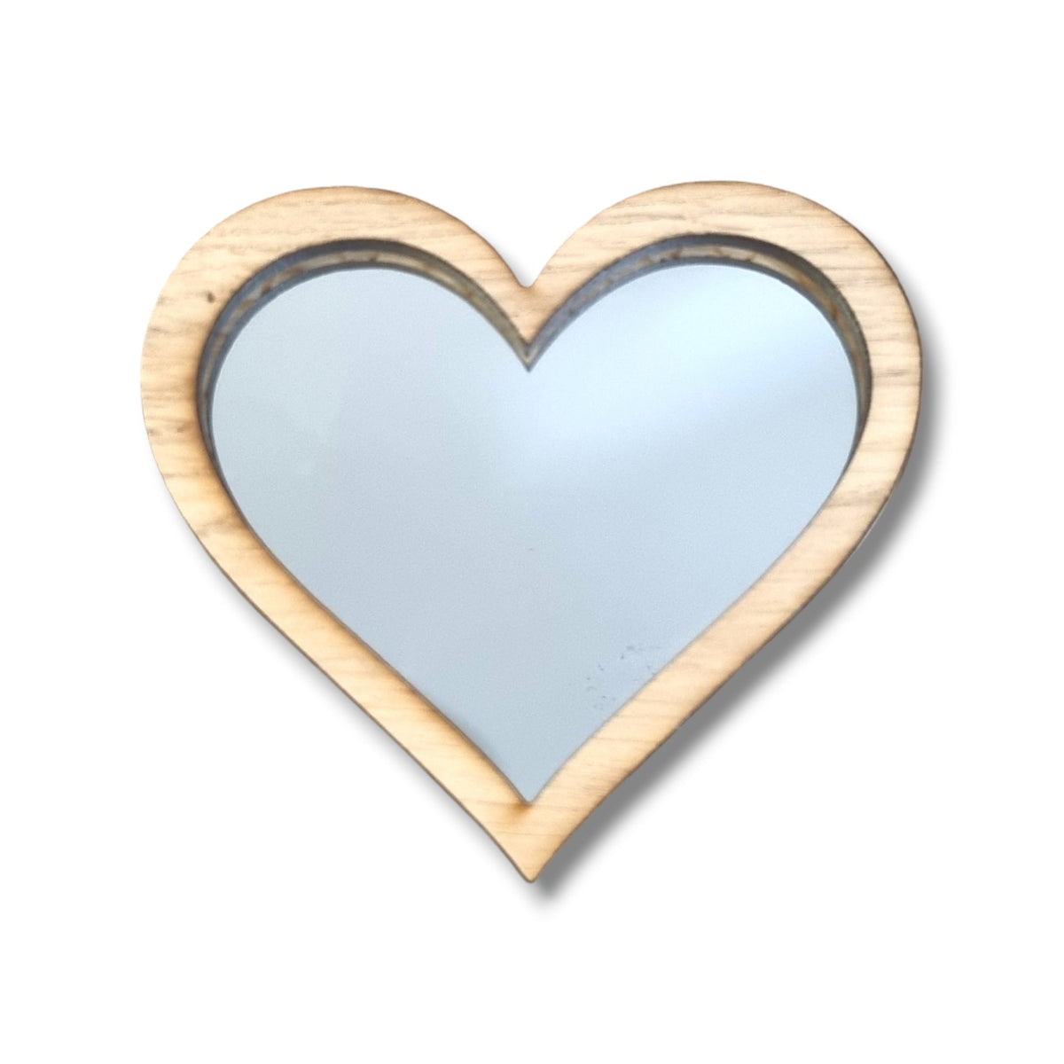 A heart-shaped mirror with a light wood frame on a white background.