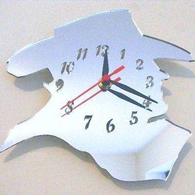 Mirrored cowboy silhouette shaped wall clock with black numbers and hands and a red second hand.