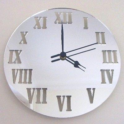 Round mirrored wall clock by SuperCoolCreations featuring black hands and engraved Roman numerals.